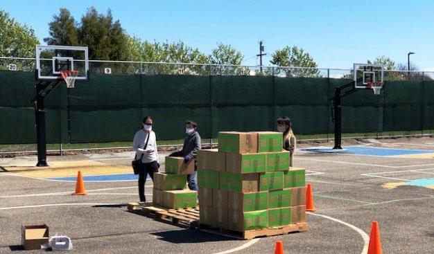 Volunteers at Los Cerritos Elementary School unload donations from Menlo Church.