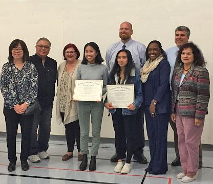 El Camino High School students Annamarie Basco and Roslyn Catiis are recognized by SSFUSD school board.
