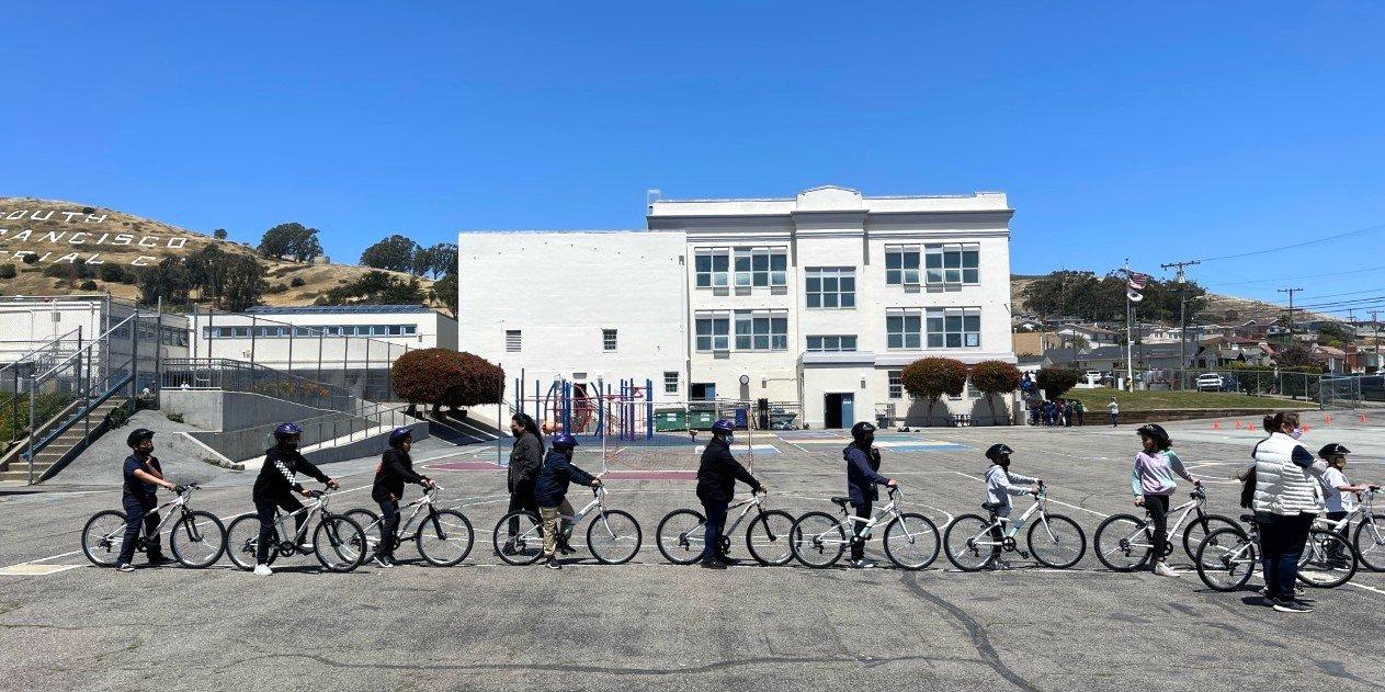 Spruce Elementary students line up to receive free bicycles through the city of South San Francisco's Every Kid Deserves a Bike program.