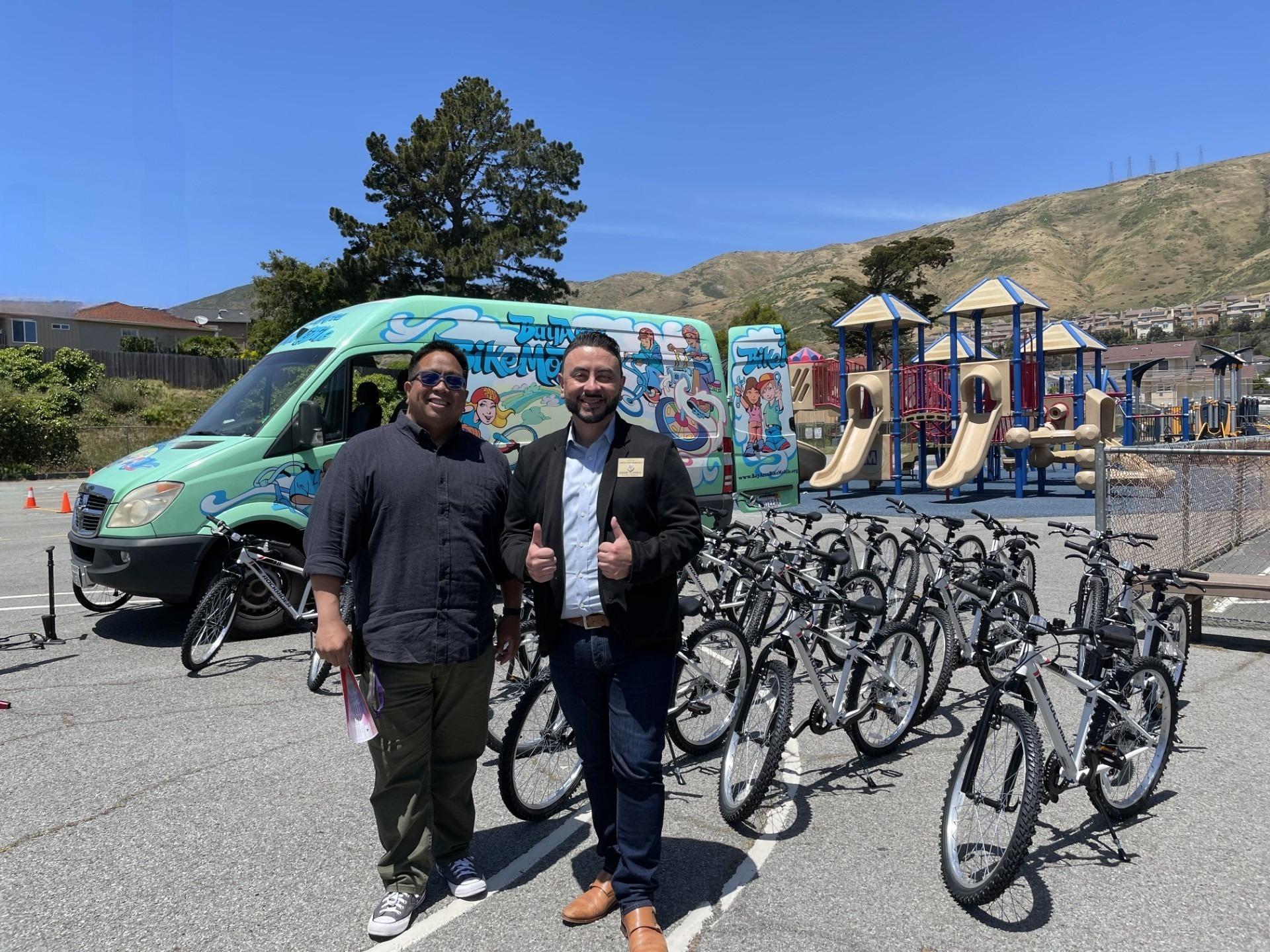 Martin Elementary School Principal Jonathan Covacha poses with South San Francisco Council Member Eddie Flores during the city of South San Francisco's 2023 bike giveaway event.