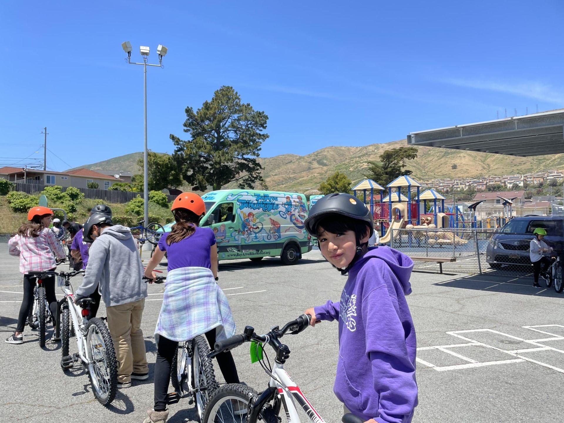 Martin Elementary School students line up to receive a bike at the city of South San Francisco's bike giveaway program on May 22, 2023.
