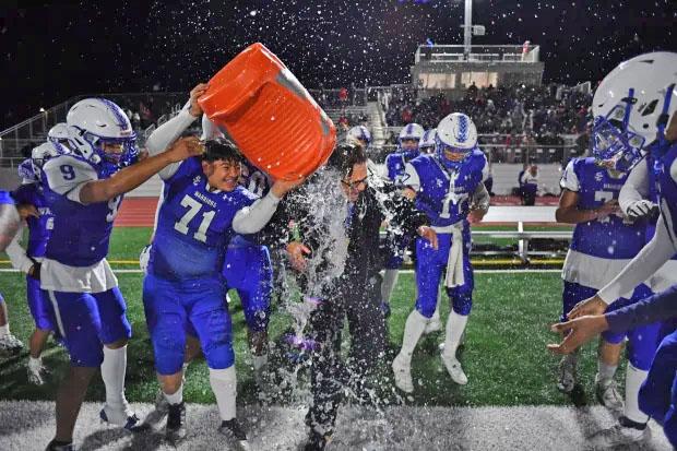South San Francisco assistant coach Frank Moro is doused with water after defeating Santa Teresa during their CCS Division V high school football championship game at MacDonald High School in San Jose, Calif., on Saturday, Nov. 25, 2023. South San Francisco defeated Santa Teresa 13-7. (Jose Carlos Fajardo/Bay Area News Group) 